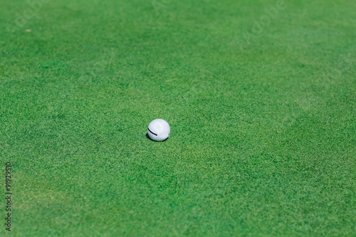 Golf ball on green course field