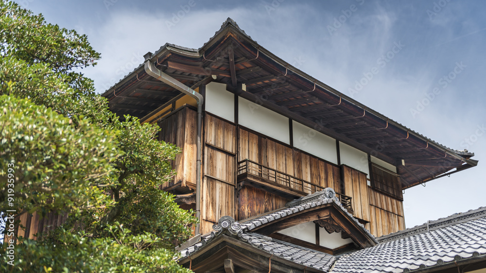 A traditional style Japanese wooden building with a tile roof