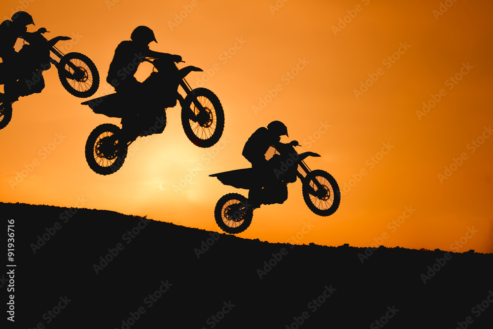 Fototapeta premium motorcycle silhouette are jumping on sunset