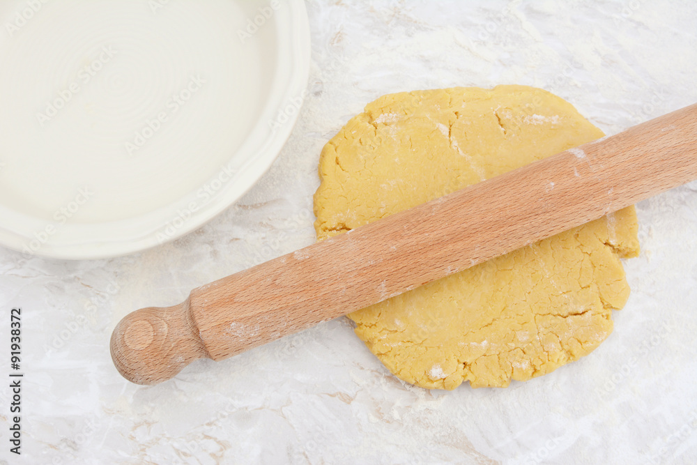 Rolling out homemade pastry with a rolling pin Rolling out homemade pastry with a rolling pin