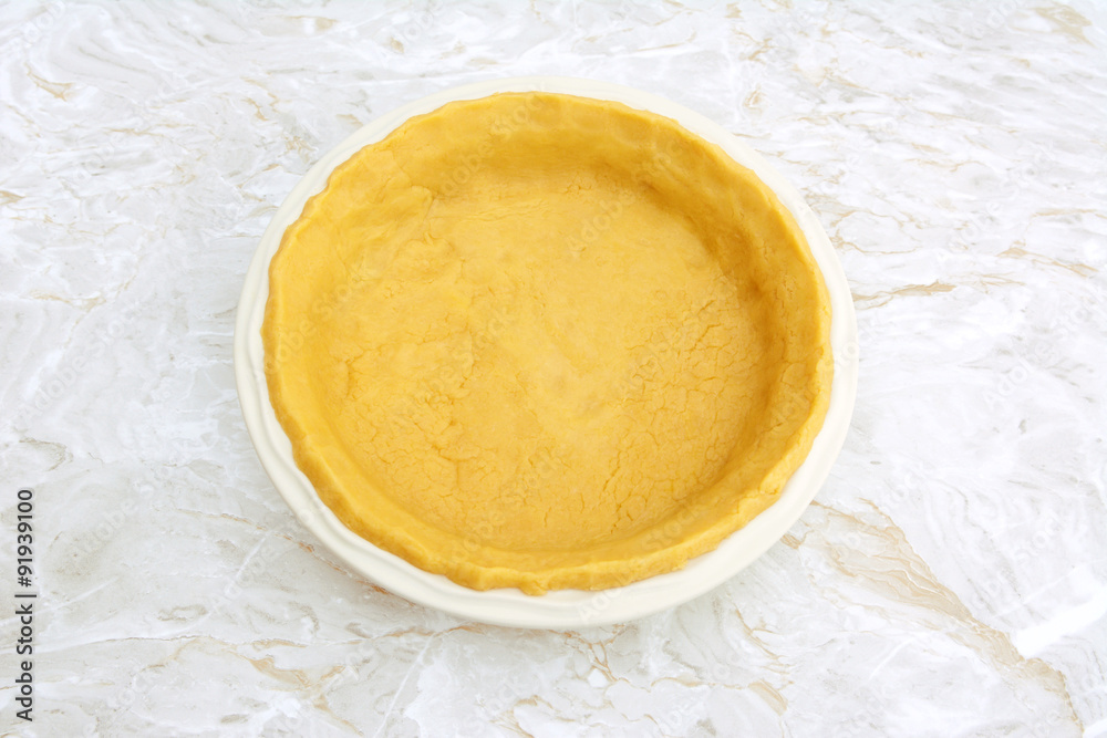 Circular pie dish lined with pastry Circular pie dish lined with pastry