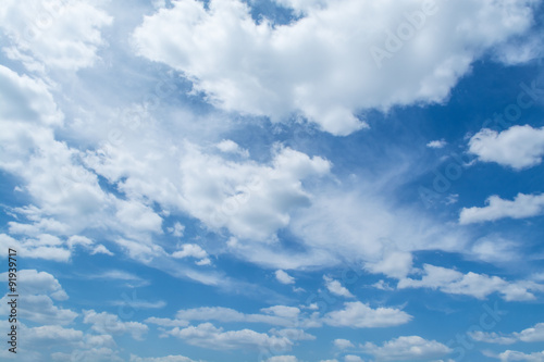 Blue sky with curly clouds