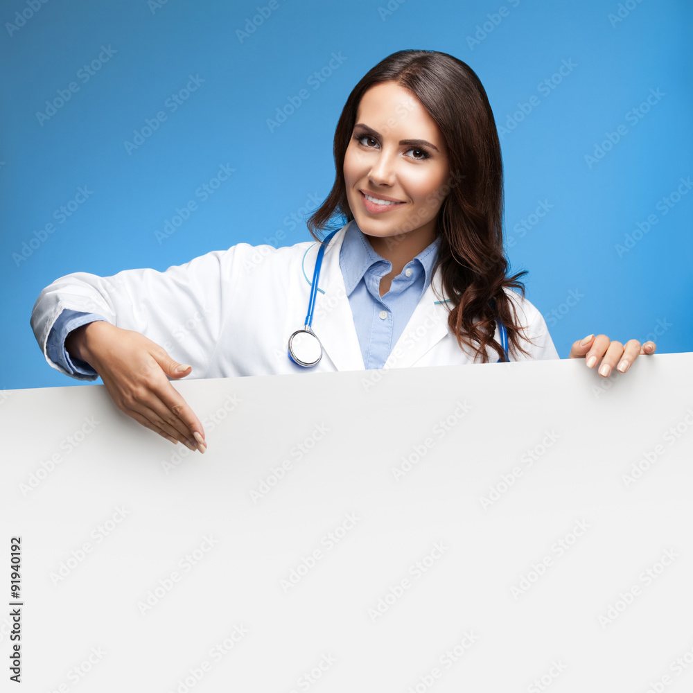female doctor showing blank signboard, over blue female doctor showing blank signboard, over blue