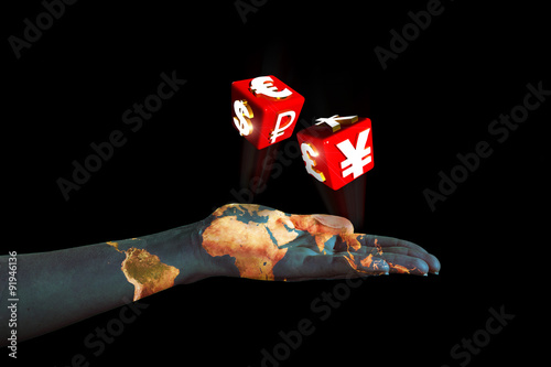 hand pulling dice with symbols of international currencies photo