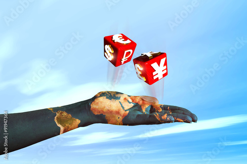 hand pulling dice with symbols of international currencies photo