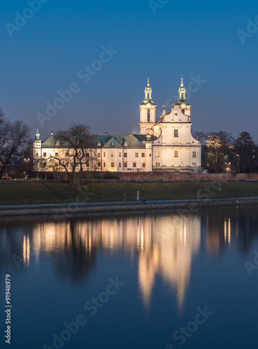 Krakow, Poland, scenic Vistula riverbank with Pauline fathers church (Skalka) in the evening #91948979