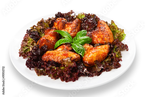 Fried roasted chicken wings on lettuce