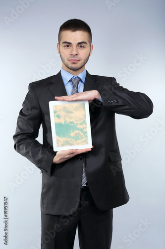 Businessman holding tablet ...