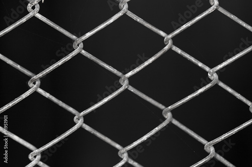 metal grid on a black background background © schankz