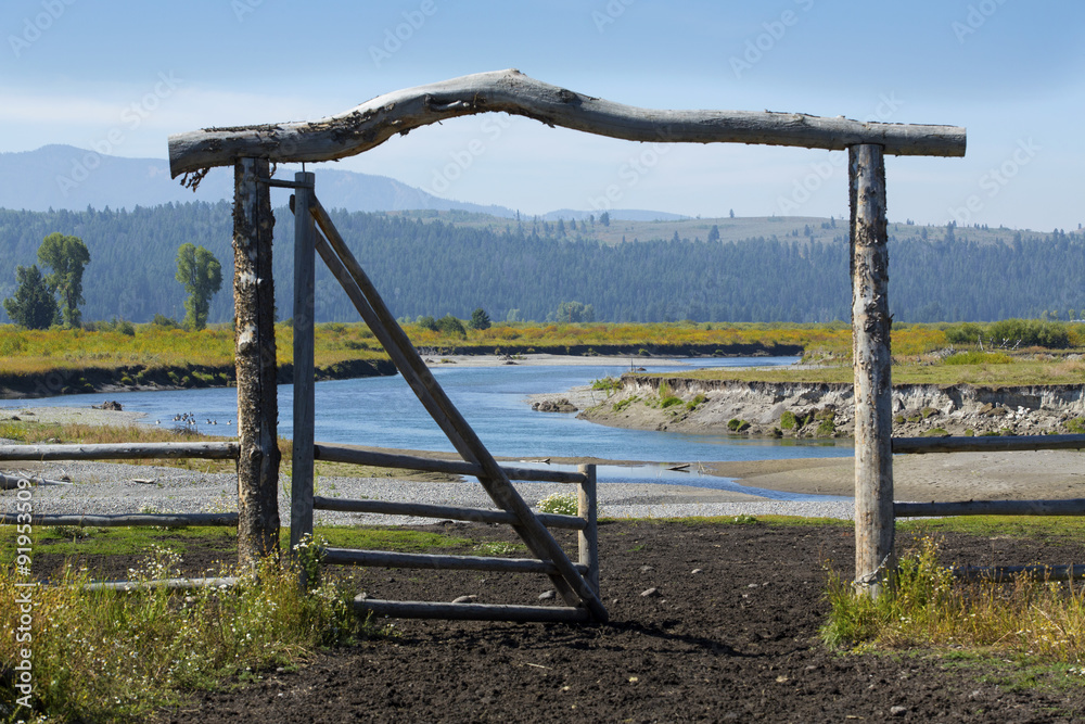 Ranch entry gate in pasture, bank of Buffalo Fork River, Wyoming Ranch entry gate in pasture, bank of Buffalo Fork River, Wyoming