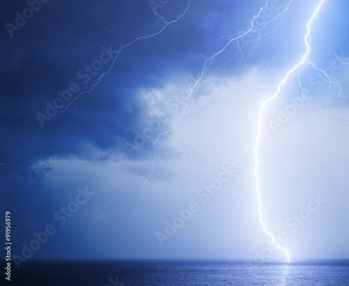 Seascape with bright lightning in blue sky