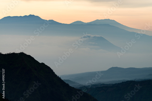 orange blue light foggy silhouette mountain range