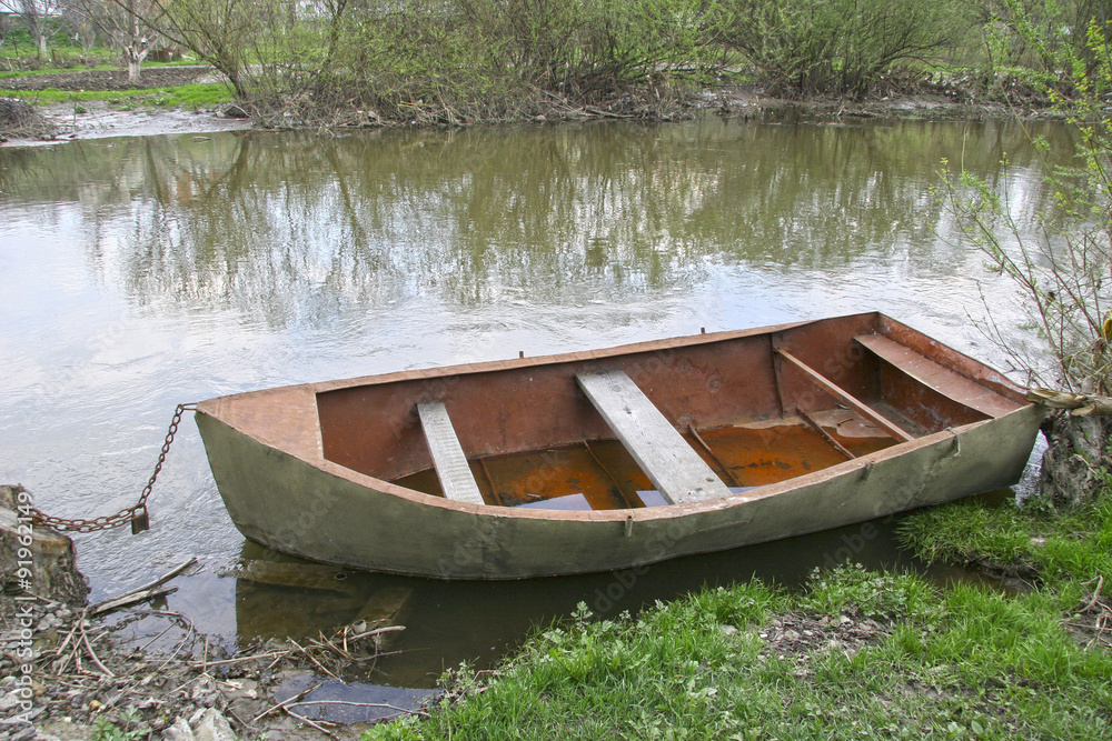 Old boat on the river spring. The concept of old age. The concep