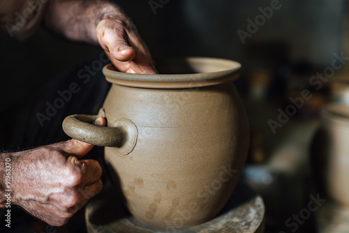 The potter make pot from clay photo