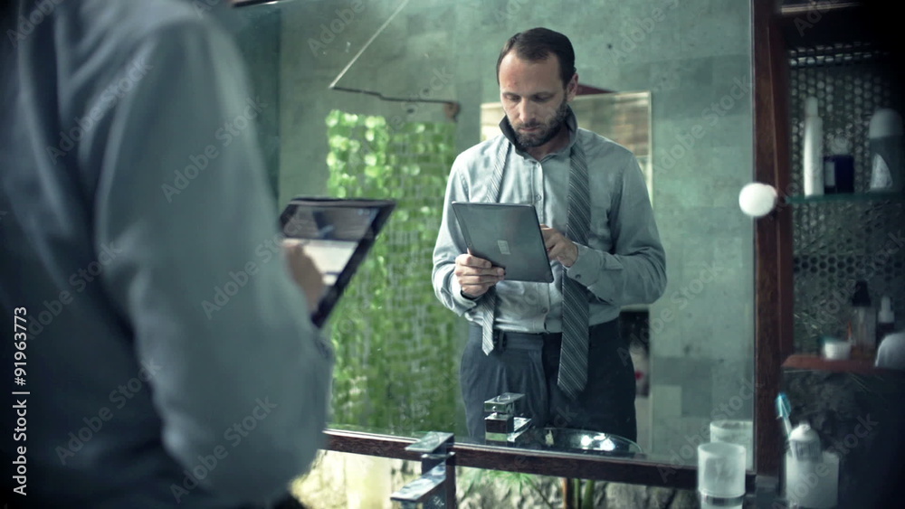 Young businessman using tablet computer standing in bathroom
Young businessman using tablet computer standing in bathroom
