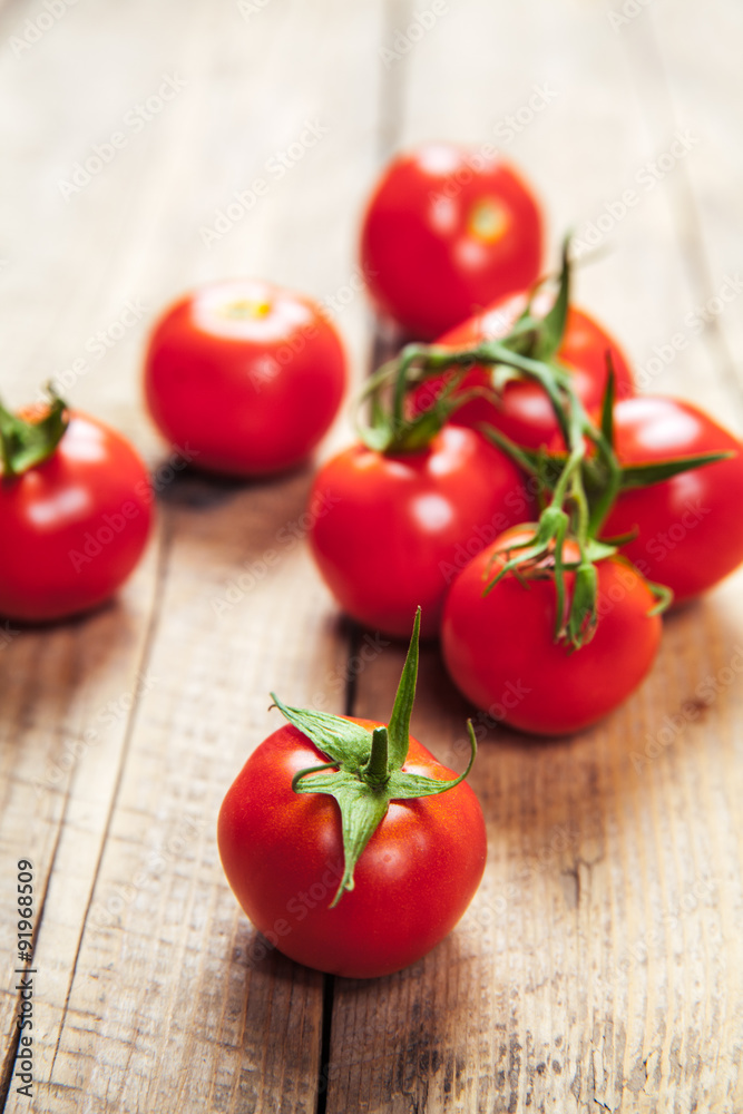 Fresh cherry tomatoes on rustic wooden background Fresh cherry tomatoes on rustic wooden background