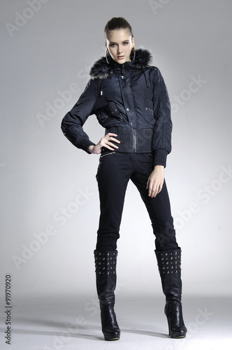 full-length portrait of young model posing on light background

