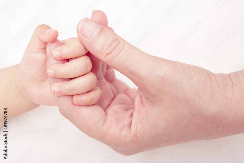 Hand the sleeping baby in the hand of mother close-up (Soft focu