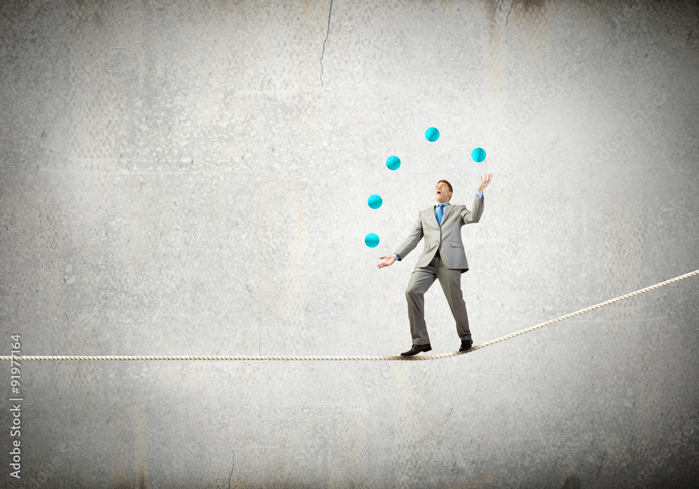 Fototapeta premium Businessman juggling with balls