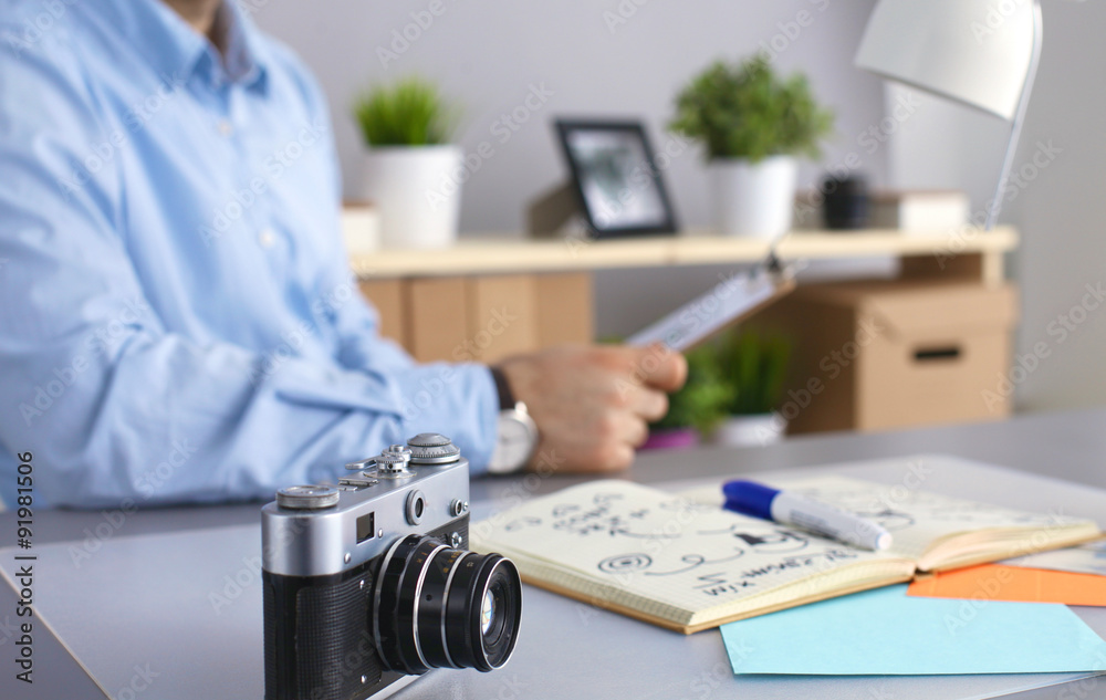 Designers table with camera and tools, cup