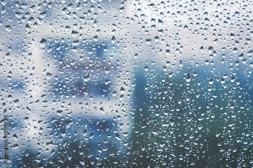 Rainy window, blurry view. Cold tones