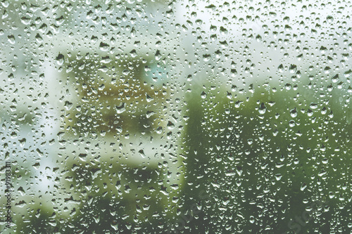 Rainy window, blurry view. Warm tones