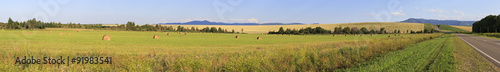 Beautiful panorama the sloping fields and haystacks.