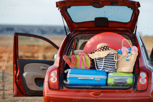 Suitcases and bags in trunk of car ready to depart for holidays