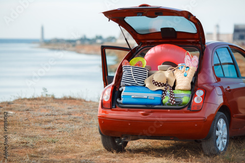 Fotografie Suitcases and bags in trunk of car ready to depart for holidays