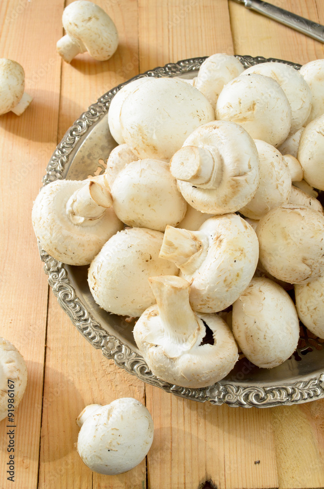 raw champignons on wooden background raw champignons on wooden background