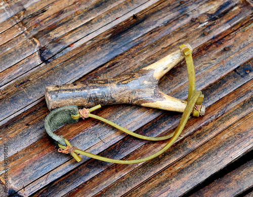 old slingshot on wooden table