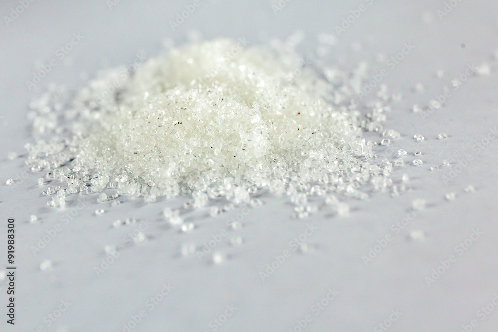 Closeup of white granulated sugar on Isolated White Background