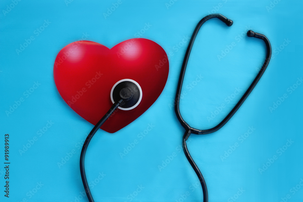 Red heart and a stethoscope on the blue background Red heart and a stethoscope on the blue background