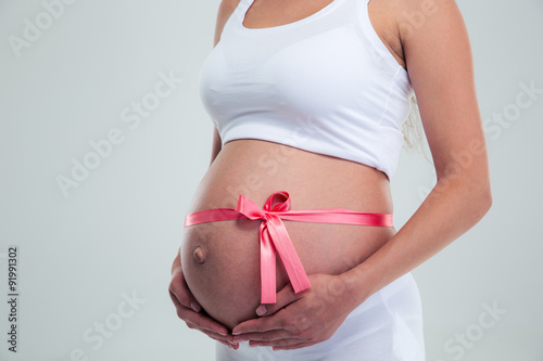 Pregnant woman with gift ribbon