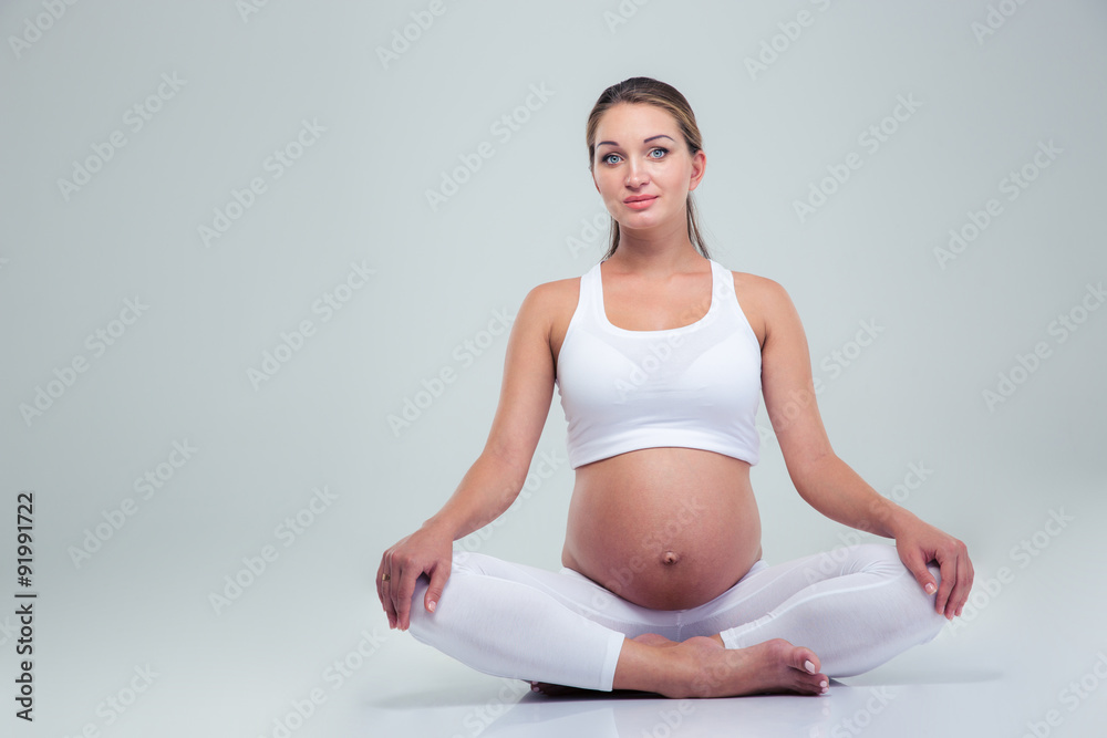 Pregnant woman sitting on the floor