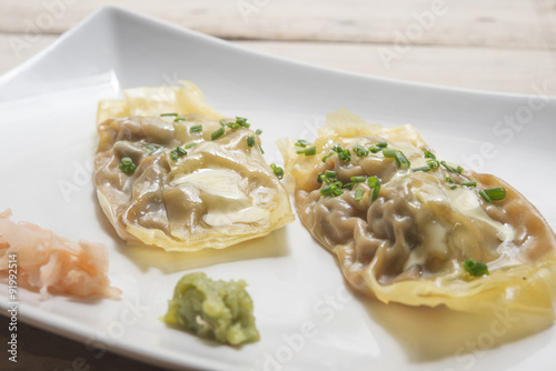 Won-ton rolls of pasta stuffed with chicken, mushrooms, onion, c