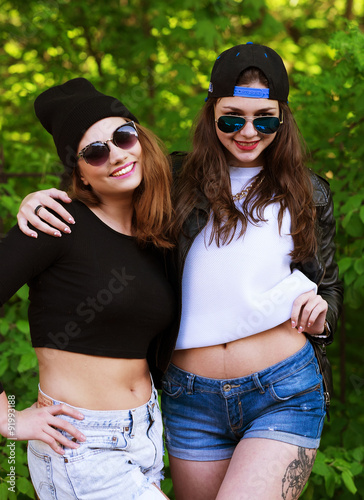 Two young hipster girl friends together having fun. 