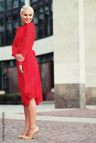 Happy beautiful woman in red summer dress
