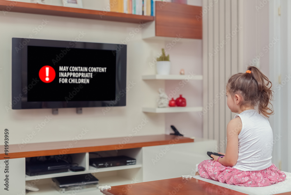 cute little girl watching tv. inappropriate content concept. Stock