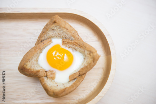 baked egg in bread bowl on wooden tray