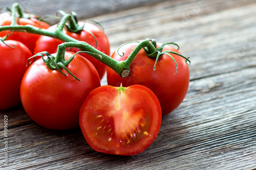 Fresh tomatoes on wood background
 photo