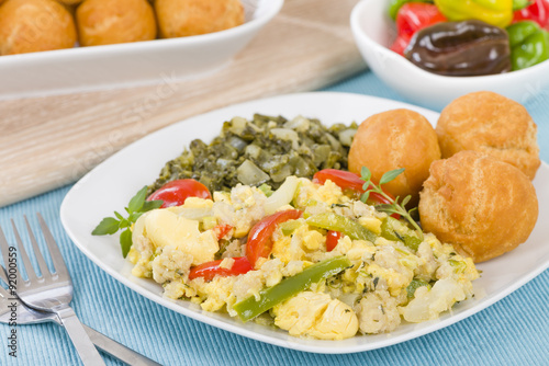 Ackee & Saltfish - Traditional Jamaican dish made of salt cod and ackee fruit. Served with callaloo and johnny cakes. 