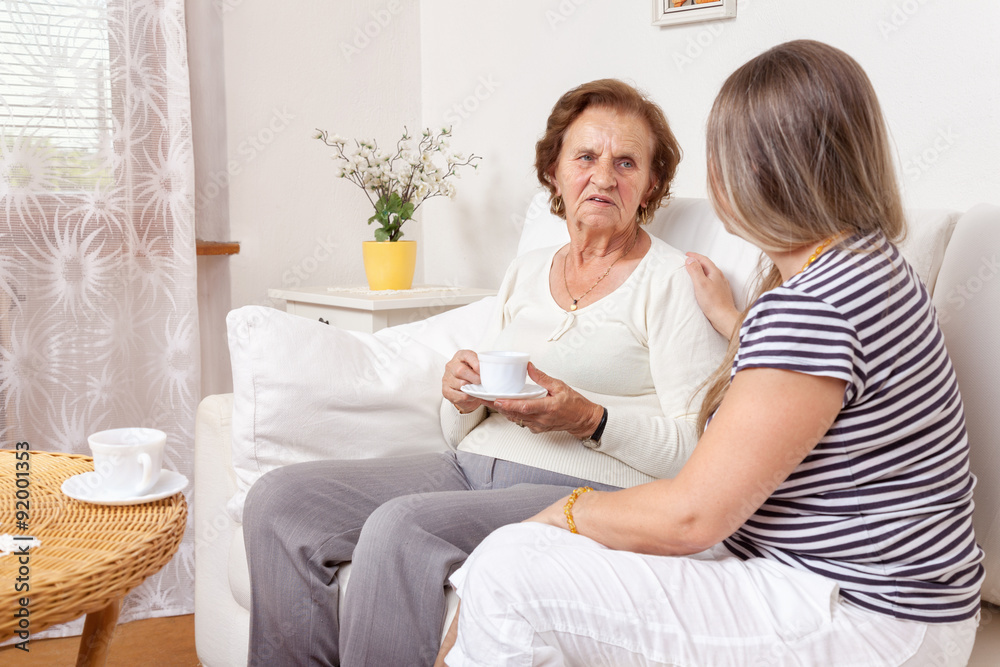 Carer having a cup of tea with an elderly woman Carer having a cup of tea with an elderly woman