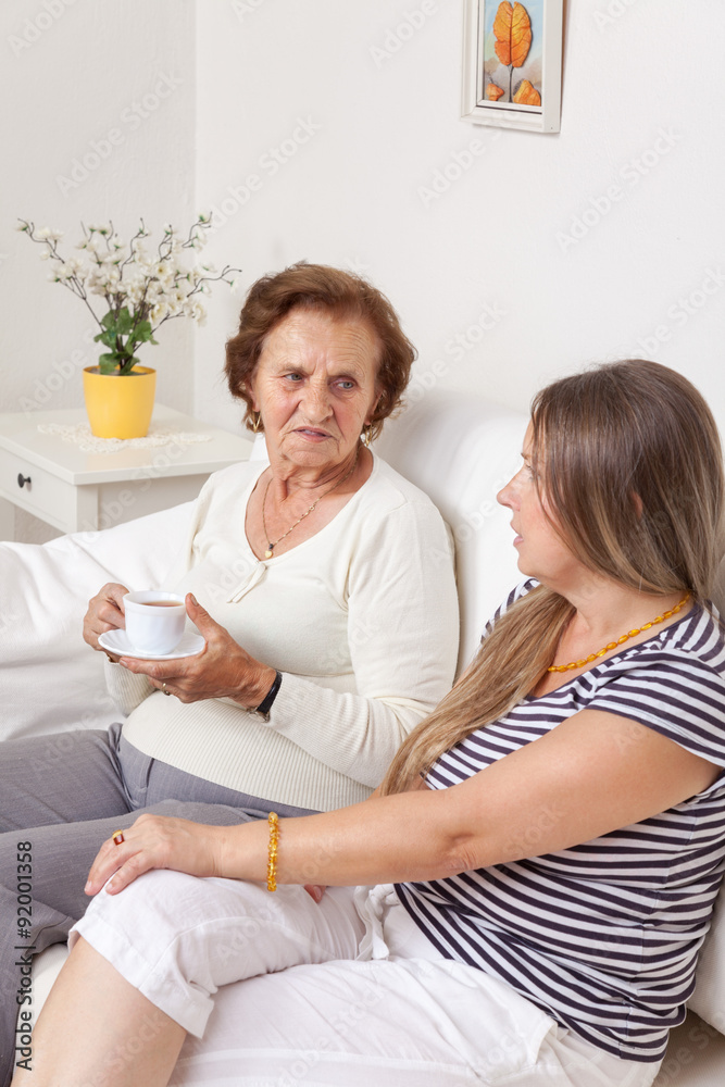 Carer having a cup of tea with an elderly woman