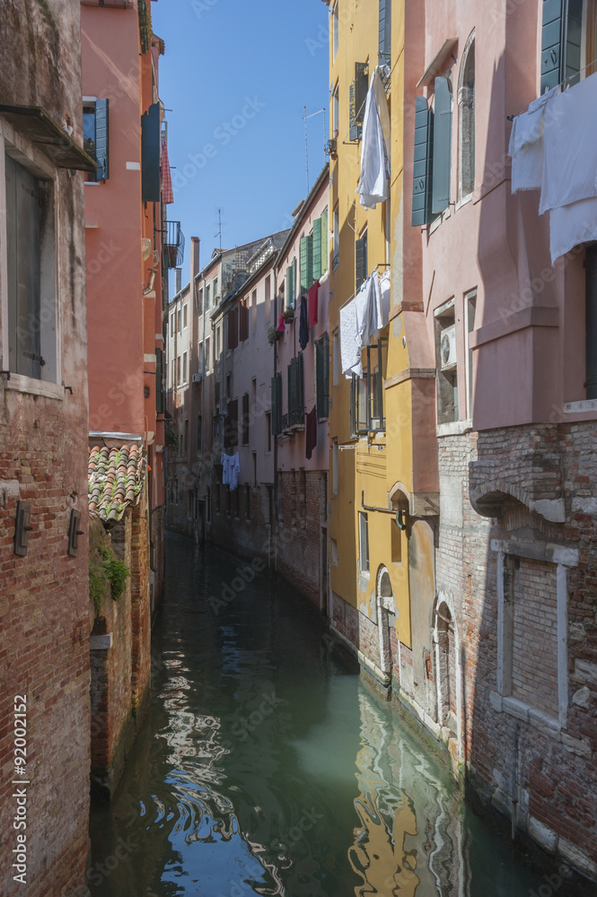 The colorful houses in tight canal , Venice. Italy 