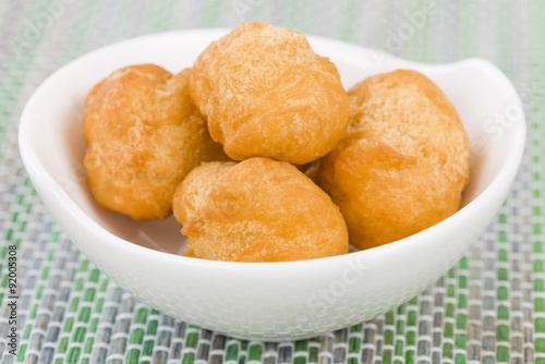 Johnny Cakes - Jamaican fried dumplings in a white bowl.

