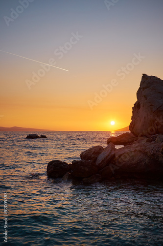 Rock island at golden sunset in Brela, Croatia