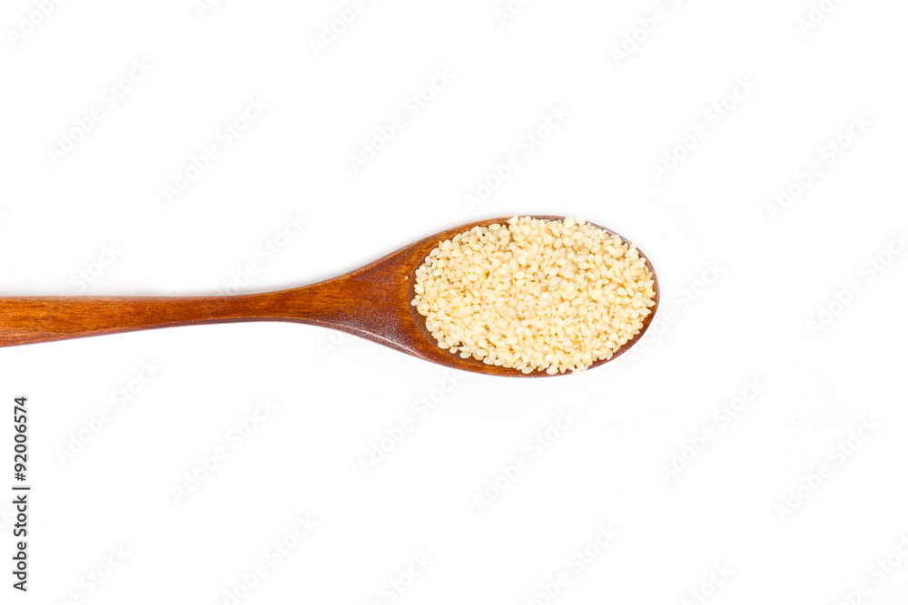 Sesame seeds on wooden spoon isolated on white background. Sesame seeds on wooden spoon isolated on white background.