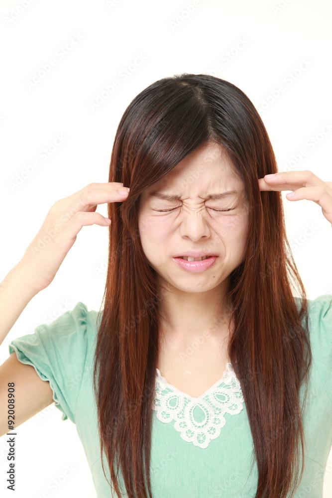 young Japanese businesswoman suffers from headache young Japanese businesswoman suffers from headache
