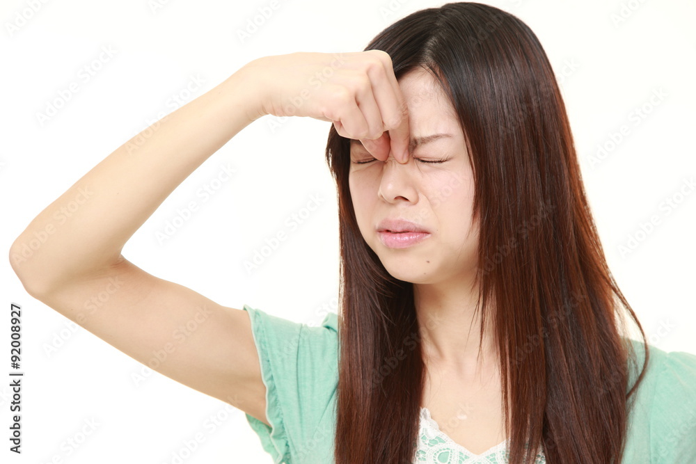 young Japanese businesswoman suffers from Asthenopia young Japanese businesswoman suffers from Asthenopia
